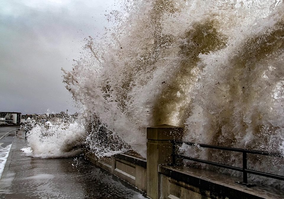 Waves crash over the top of the seawall in Hampton, NH