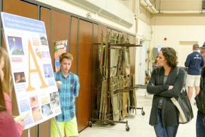 Students present a poster about climate change at a Climate in the Classroom event