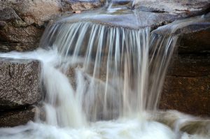 Close up of water flowing over rocks