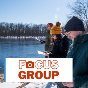 Students reading handout and looking at river in winter