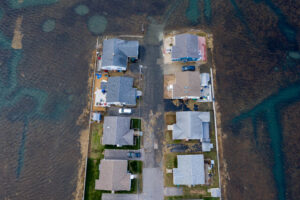 overhead image of neighborhood surrounded by flooded marsh