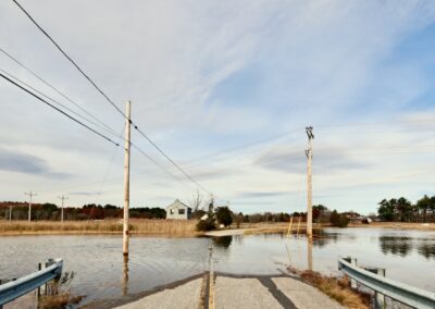 A bridge through a marsh is flooded