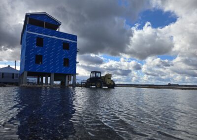 A house on stilts is flooded underneath