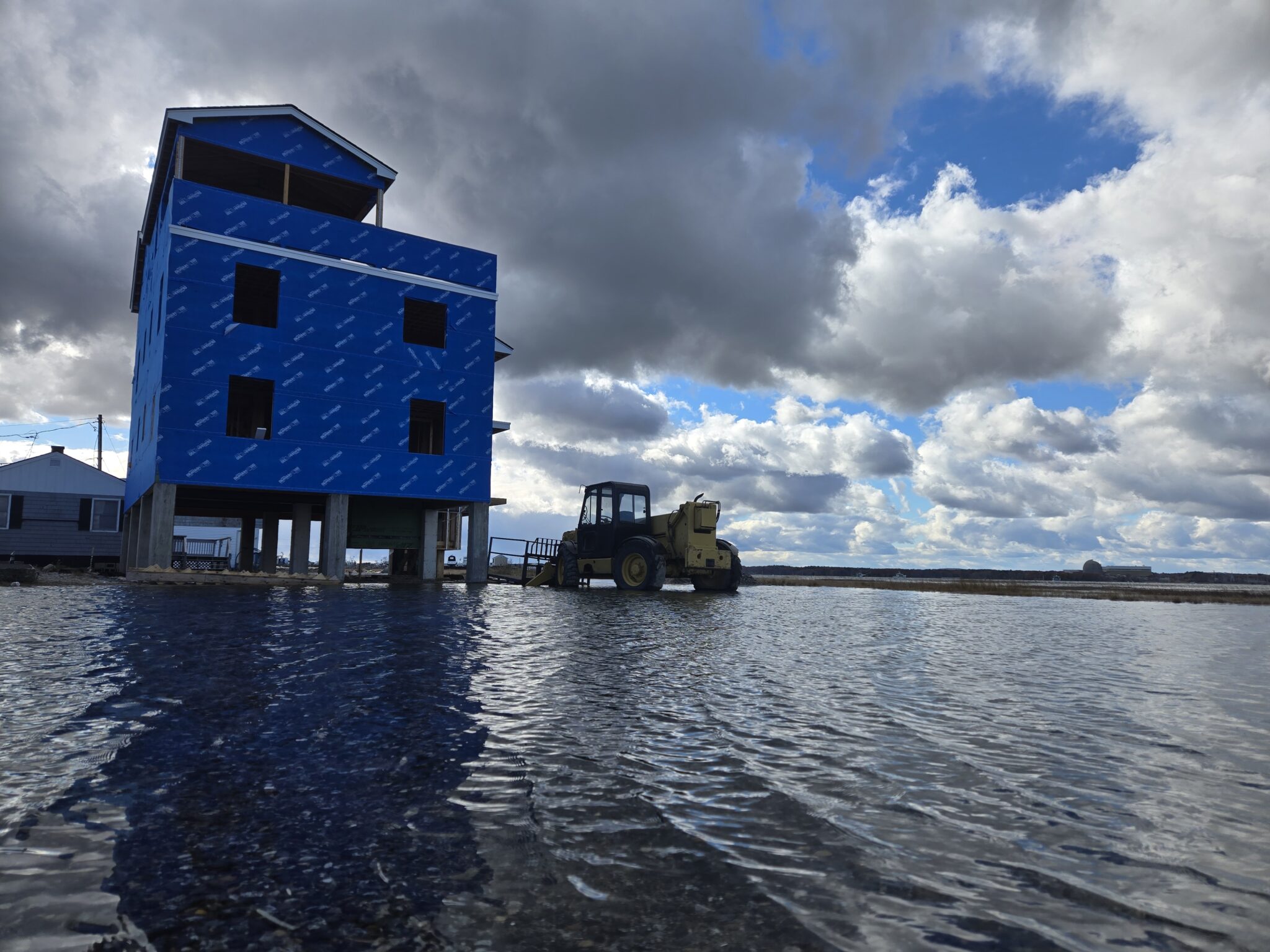 A house on stilts is flooded underneath