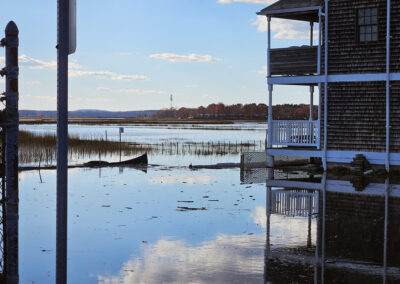 House and lawn flooded with reflection of blue sky in water