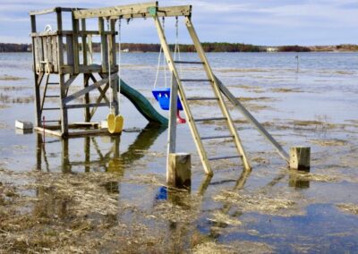 A kids playground by the coast is partially underwater.