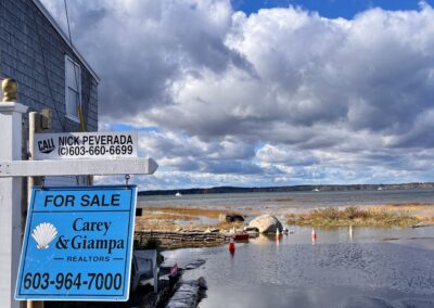 A road next to a house ends in a large flooded area