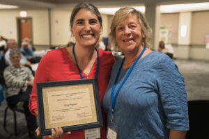 Tracy Degnan accepts community champion award from Rayann Dionne