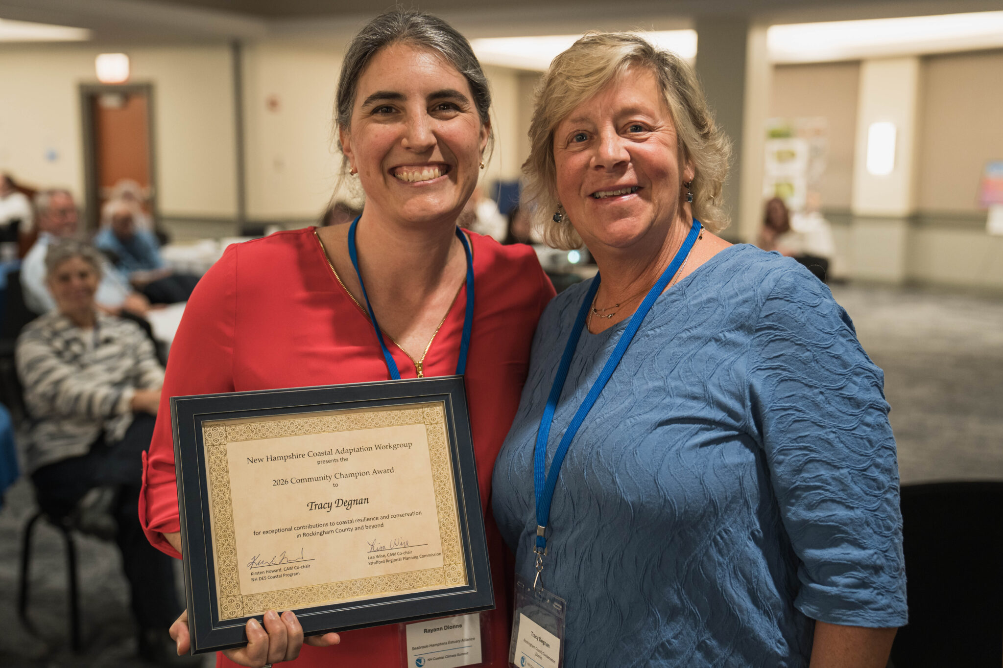 Tracy Degnan accepts community champion award from Rayann Dionne