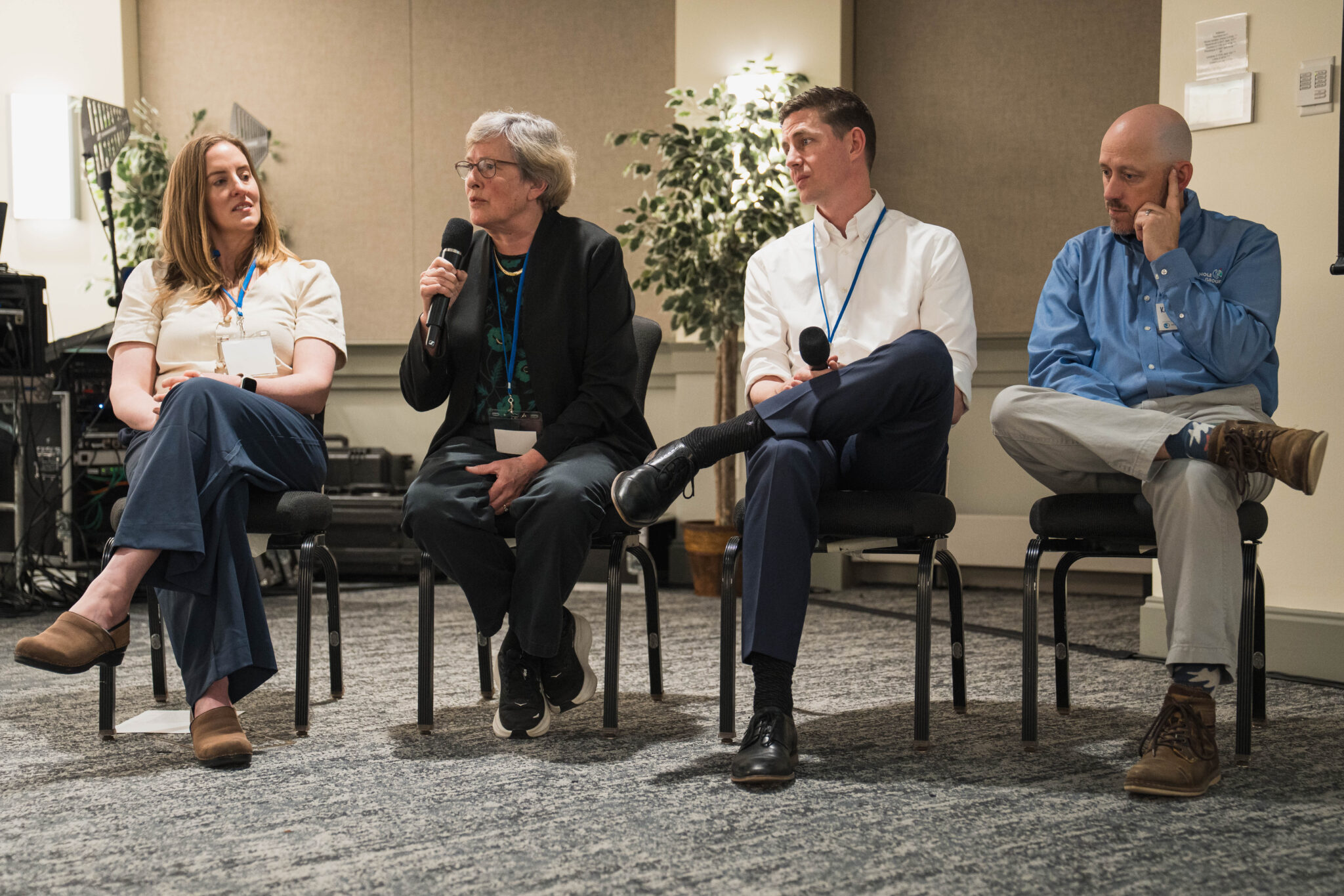 A panel of four people sit in a row.