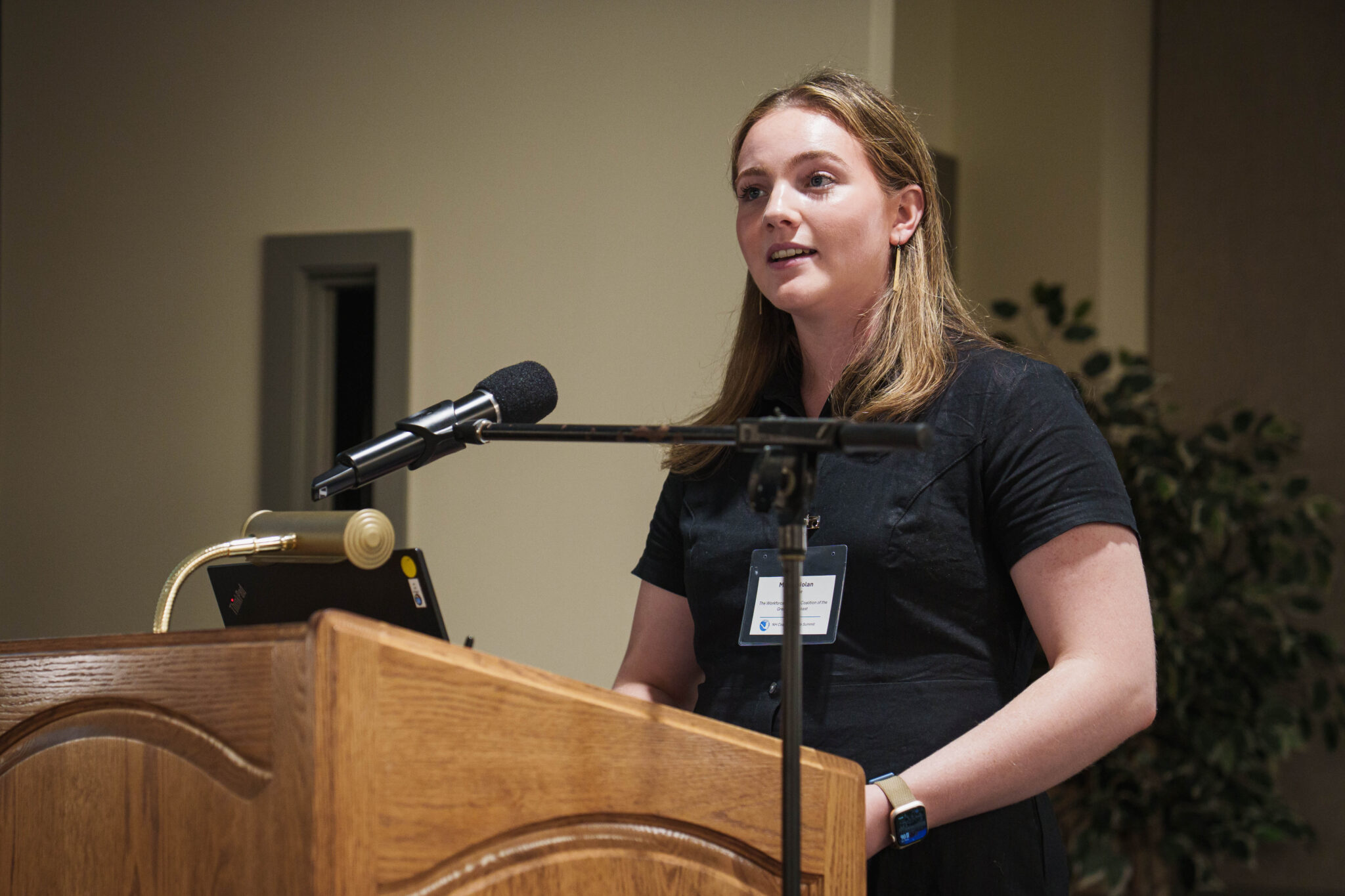 A woman gives a presentation at a podium
