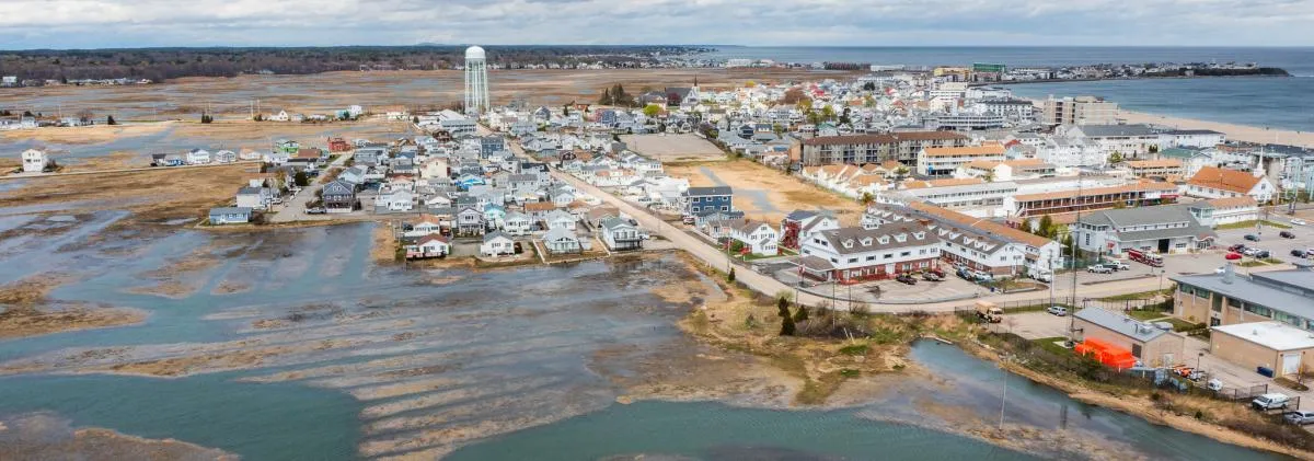 A neighborhood with a water town flooding, as seen from above.
